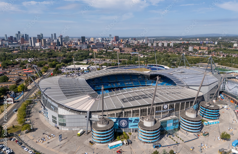 Obraz premium Etihad Stadium aerial view in Manchester, England, home of Manchester City Football Club, showing the football ground, pitch and surrounding Etihad Campus.