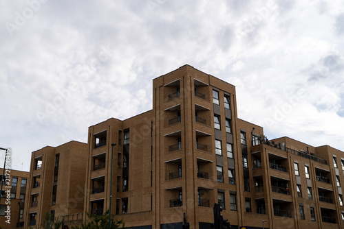 Canvas Print Modern Residential Apartment Buildings Under Cloudy Sky in Urban Setting
