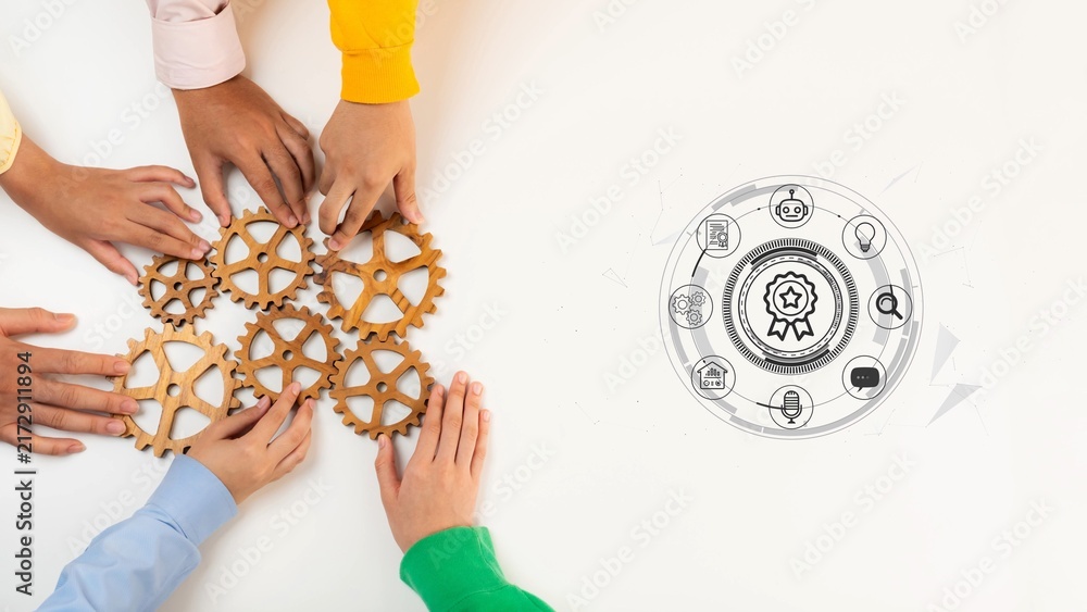 Obraz premium Group of Diverse Hands Collaborating to Assemble Wooden Gears Representing Teamwork, Innovation, and Problem Solving in a Modern Business Setting. Entropy.