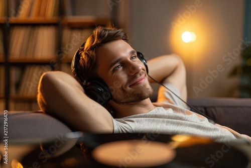 Relaxed man listening to music in cozy home