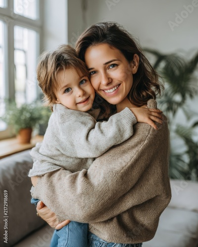 Mother and young daughter sharing affectionate hug at home