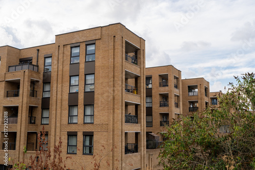 Photography Modern Apartment Complex with Multiple Floors and Balconies Under Cloudy Sky