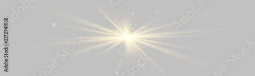 Fotografie Gold light beams radiate outward against a black background in multiple directions