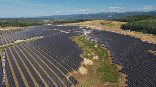 Reflective Solar Farm Beneath Distant Mountains
