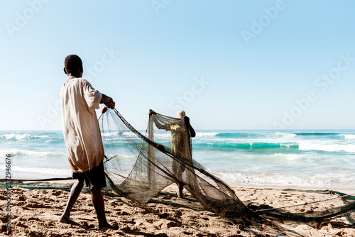 Foto Rural fishermen with their fishing net on the beach