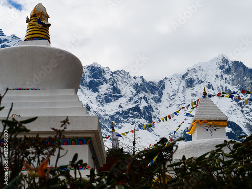 Photography Buddhist stupas with prayer flags against snow-covered Himalayan mountains in Kh