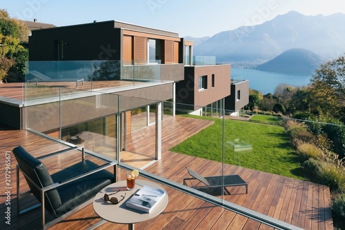 Ultra Modern Villa with Wooden Deck, Sunbed, Glass Windows, and Panoramic Lake Mountain View