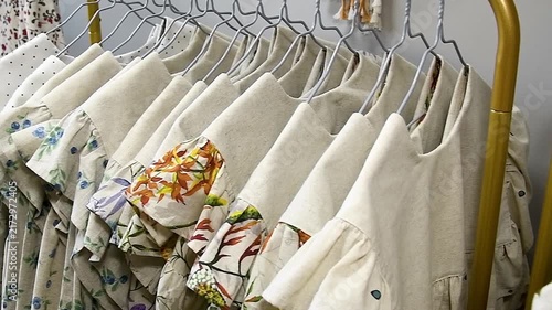 An assortment of women's clothing neatly hung on a metal hanger in a boutique or clothing store.