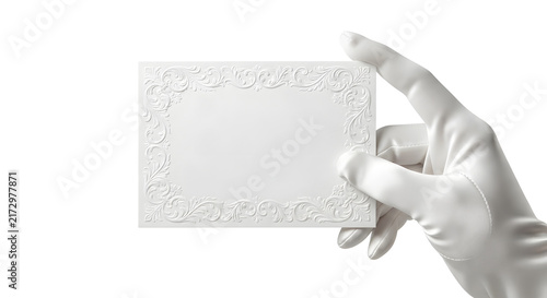Hand in white glove holding elegant ornate white invitation card
