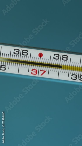 Close-up of a medical thermometer showing temperature readings
