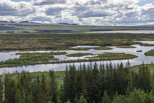 Fotografie Reflective wetlands open toward mountains in Thingvellir National Park, Iceland