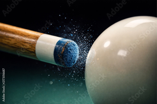 Close-up of a billiard cue striking a colorful pool ball on a table, capturing the precise moment of impact and dynamic motion, AI-generated image