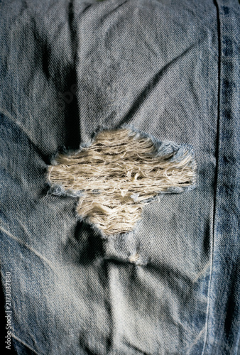 close up of ripped denim blue jeans