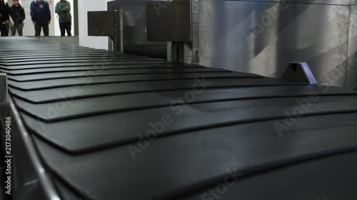Close up of the baggage conveyor at an airport moving and stopping, 4k