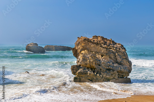 Rocks on the Bay of Biscay in Biarritz, France. Sunny daylight with blue sky. Atlantic ocean coast