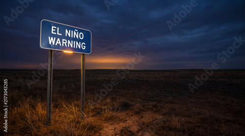 El Niño Warning Road Sign in Night Landscape Under Dark Sky. Illuminated Roadside Caution Sign Highlighting Climate Change and Weather Risks.