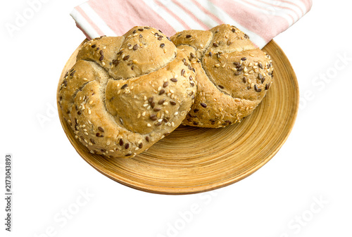 Foto Seeded Kaiser rolls with sesame and flax multigrain topping on a wooden plate with striped napkin, isolated on transparent background