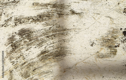 An abstract distressed wall texture featuring cream and gray tones, rough plaster details, dark brush marks, scratches, and weathered patterns. 