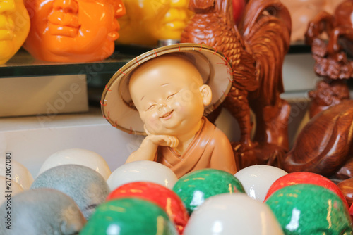Konstfotografi Smiling little monk figurine in conical hat for cute feng shui home decor, tiny