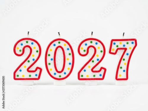 Colorful birthday candles shaped as the number 2027 isolated on white background