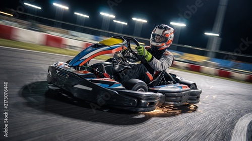 Go kart corners at speed under indoor lights