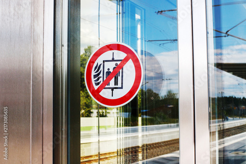 Do Not Use Elevator in Case of Fire Warning Sign on Glass Door