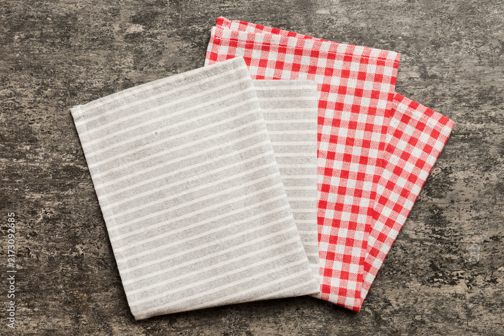Obraz premium top view with gray kitchen napkin isolated on table background. Folded cloth for mockup with copy space, Flat lay. Minimal style