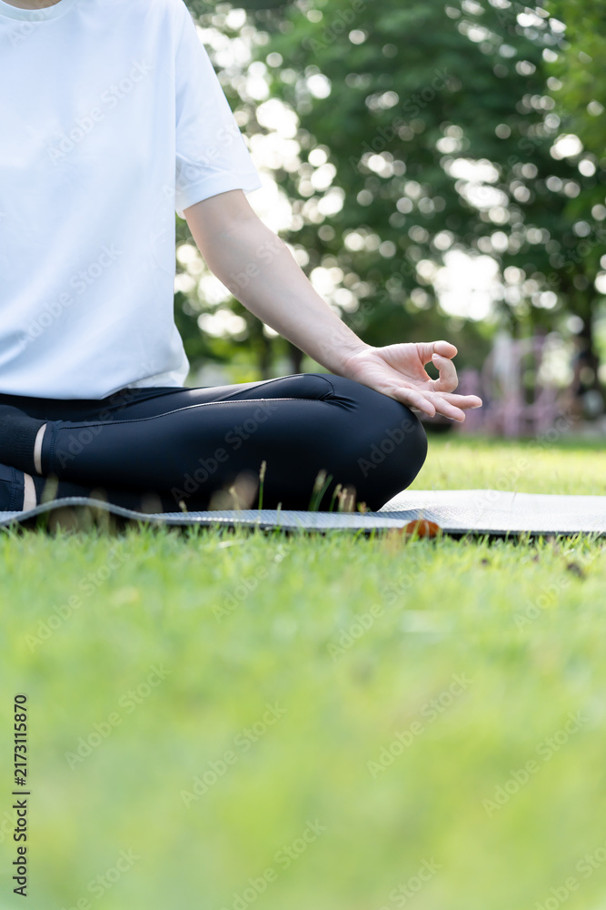 Fototapeta premium woman practicing meditate on the park. Asian woman doing exercises in morning. balance, recreation, relaxation, calm, good health, happy, relax, healthy lifestyle, reduce stress, peaceful, Attitude.