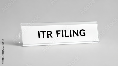A clear office desk name plate displaying the text ITR filing, representing tax return submission and financial obligation