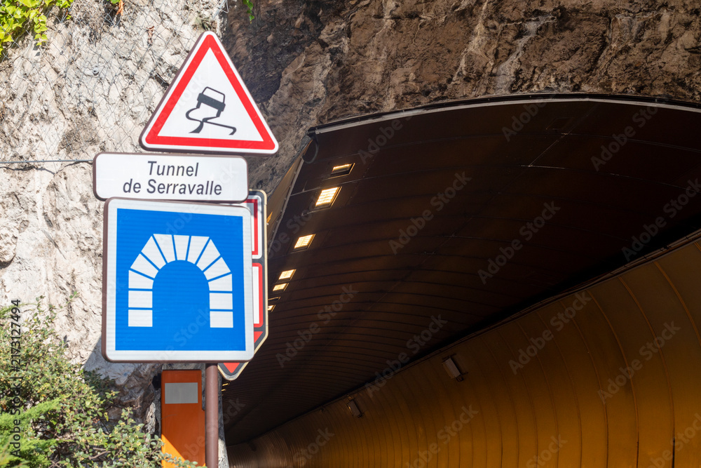 Naklejka premium Illuminated underground highway tunnel in Monaco where car races take place with road signs
