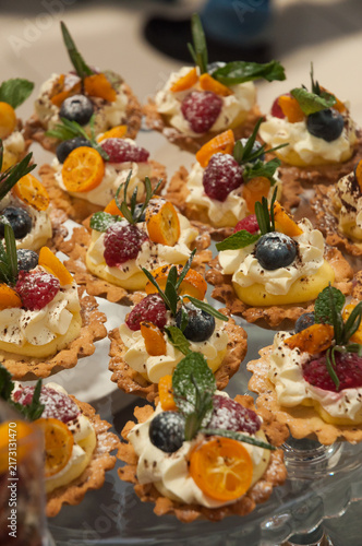 Assorted Fruit Tartlets with Cream, Kumquat, Raspberries and Blueberries