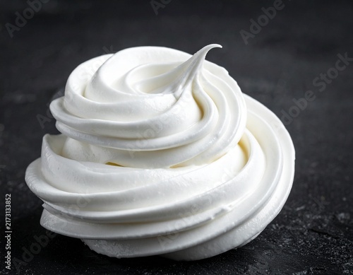 Single Meringue Swirl on Dark Background, White Whipped Cream Rosette
