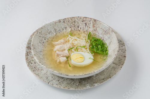 Foto Chicken Noodle Soup with Hard-Boiled Egg Isolated on White Background