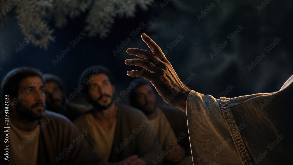 Obraz premium Hand of Jesus reaching toward disciples at night in garden of Gethsemane. Christ teaching men to pray on Mount of Olives. Biblical scene. Faith, prayer and devotion concept.