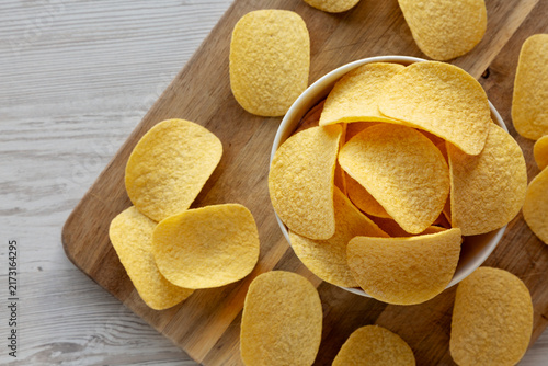 Crispy Cheese and Onion Flavoured Potato Chips in a Bowl, top view. Copy space.