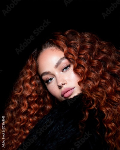 Beauty Portrait of a Model with Voluminous Curly Auburn Hair