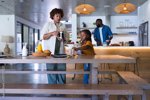 African American family making breakfast at home mom pouring French press coffee