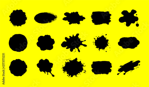 Collection of grunge paint splatters and blobs on yellow background for design