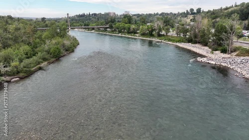 low level flying above Bow River next to Prince’s Island Park, towards to Bow River Pathway Bridge at Memorial Dr, located next to Downtown Calgary ( Alberta, Canada) - 4k aerial video footage 