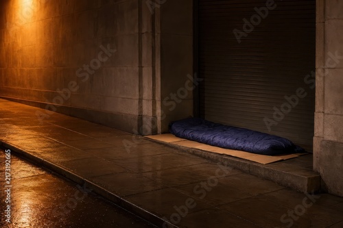 Sleeping bag and flattened cardboard in a shop doorway