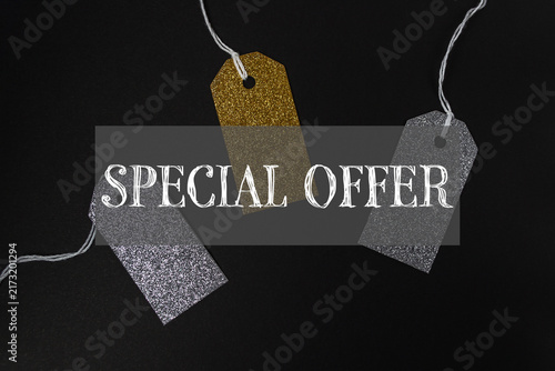 Three glittery price tags in gold and silver on a dark background with the text 'Special Offer', suggesting a promotional sale or discount.