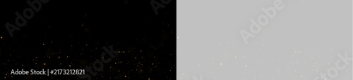 Fotografía A multitude of tiny golden particles glimmer gently against a deep black backdrop