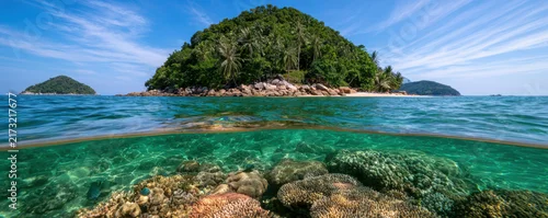 Panel kuchenny z motywem Tropical island with lush green palm trees surrounded by clear blue ocean water and vibrant coral reef beneath surface
