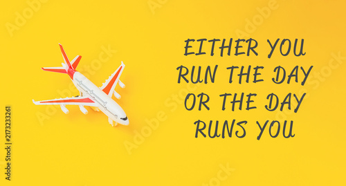A toy airplane placed on a vibrant yellow background next to a motivational quote, suggesting themes of travel and personal empowerment.