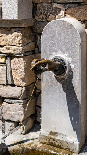 Canvas Print Old stone fountain with bronze animal water spout