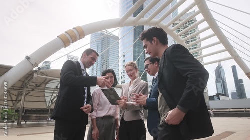 Team of experts collaborating and sharing ideas in an outdoor urban environment