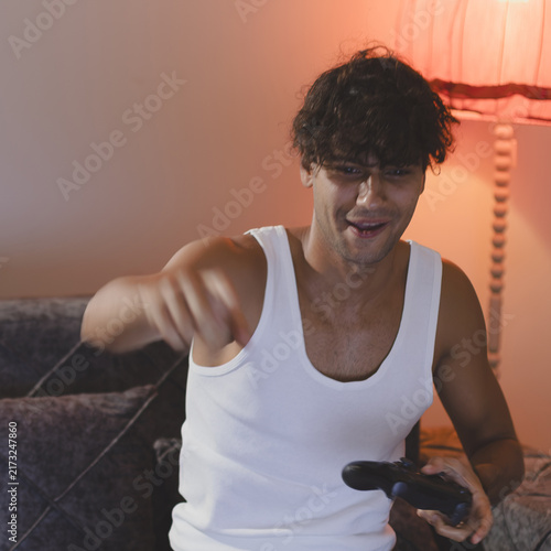 Фотография Young man engrossed in playing video games.