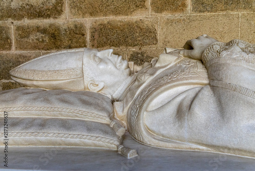 View of the marble effigy of a bishop resting on a tomb inside the Cathedral of Evora in Evora, Distrito de Evora, Portugal.