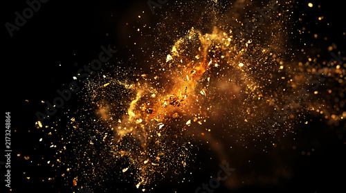 Stunning golden glitter explosion and sparkling dust particles on black