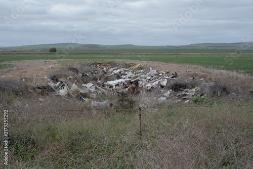Canvastavla Large pile of trash lies in open field